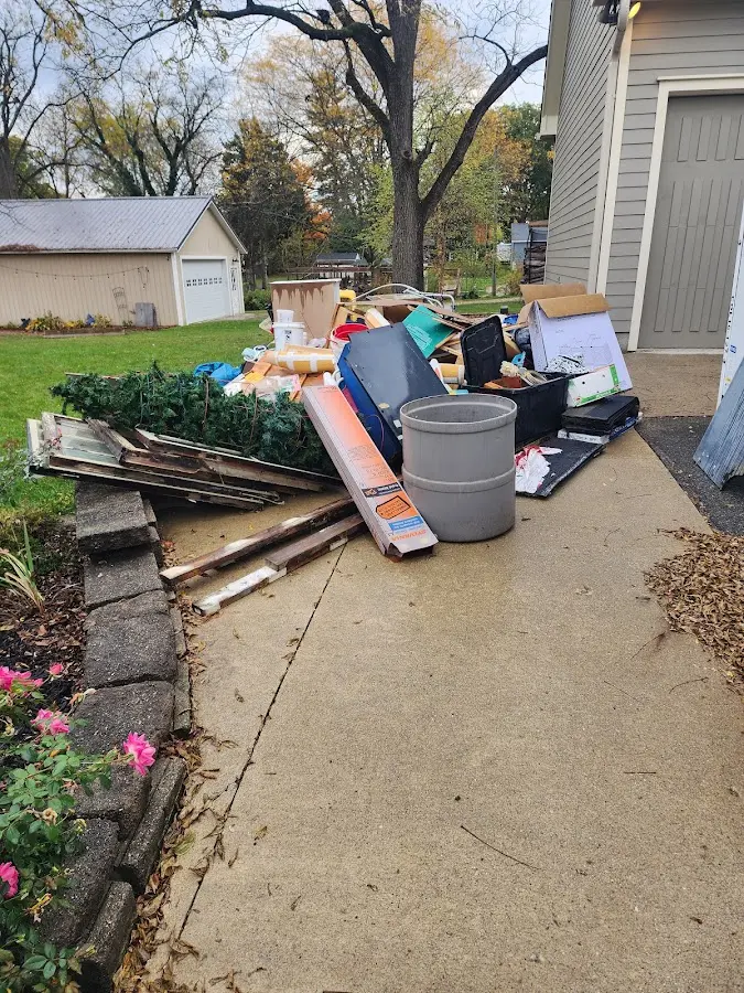 Dumpster being loaded with debris for Roofing Dumpster Rental in Fort Meade